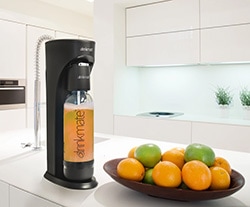 A bowl of oranges on a kitchen counter, with DrinkMate and Carbonation