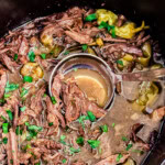 ladle lifting Mississippi Pot Roast out of crockpot