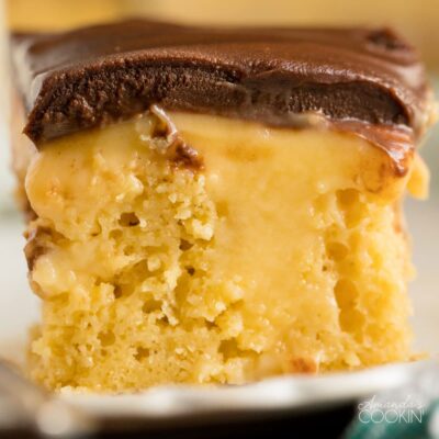 close up of a slice of Boston cream poke cake showing pudding inside