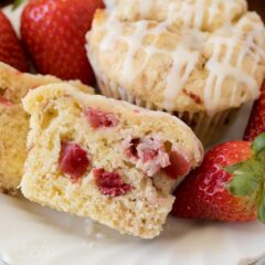 strawberry muffin sliced in half showing strawberries inside