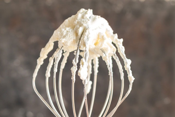 whisk attachment covered in whipped cream