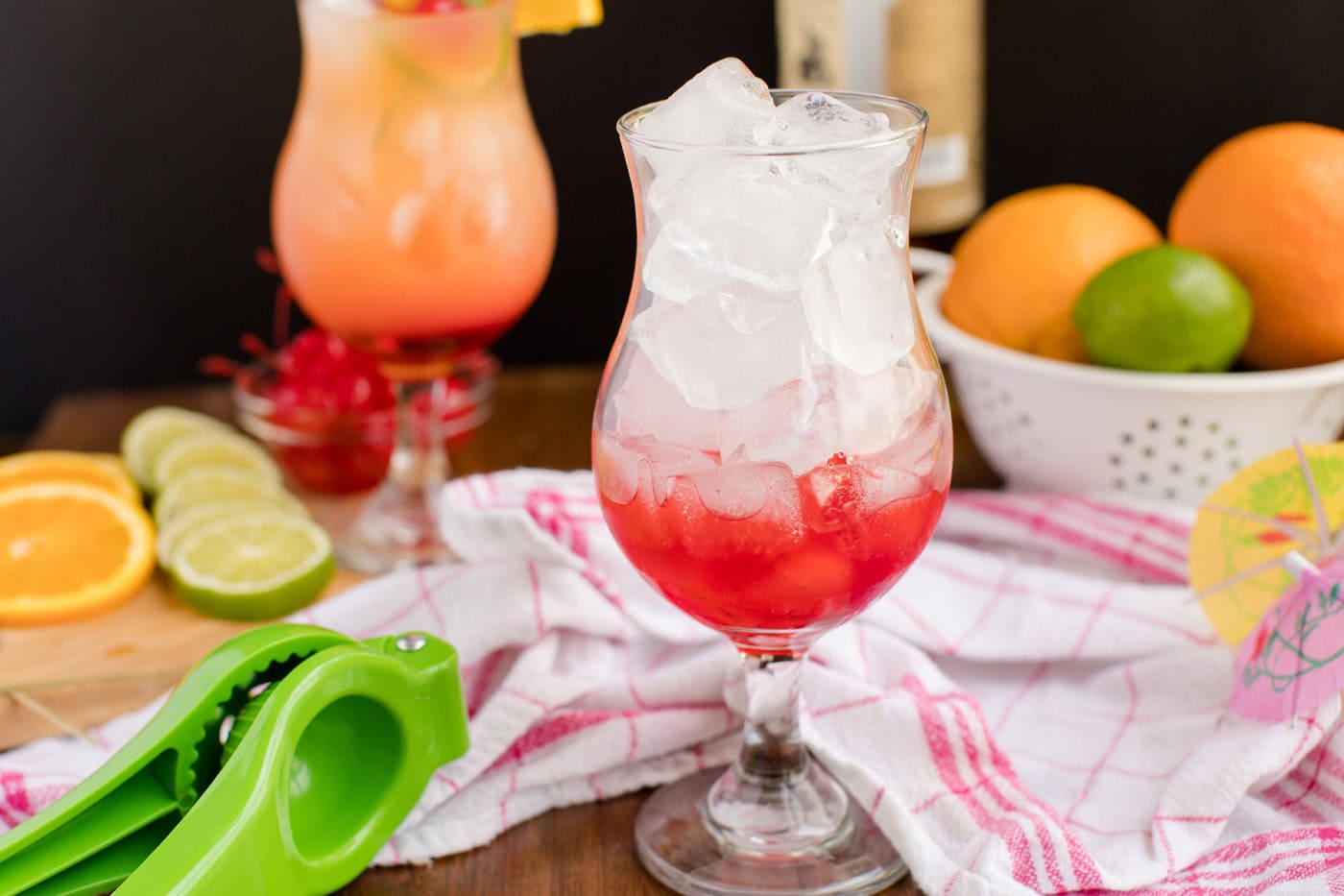glass filled with ice, grenadine at the bottom