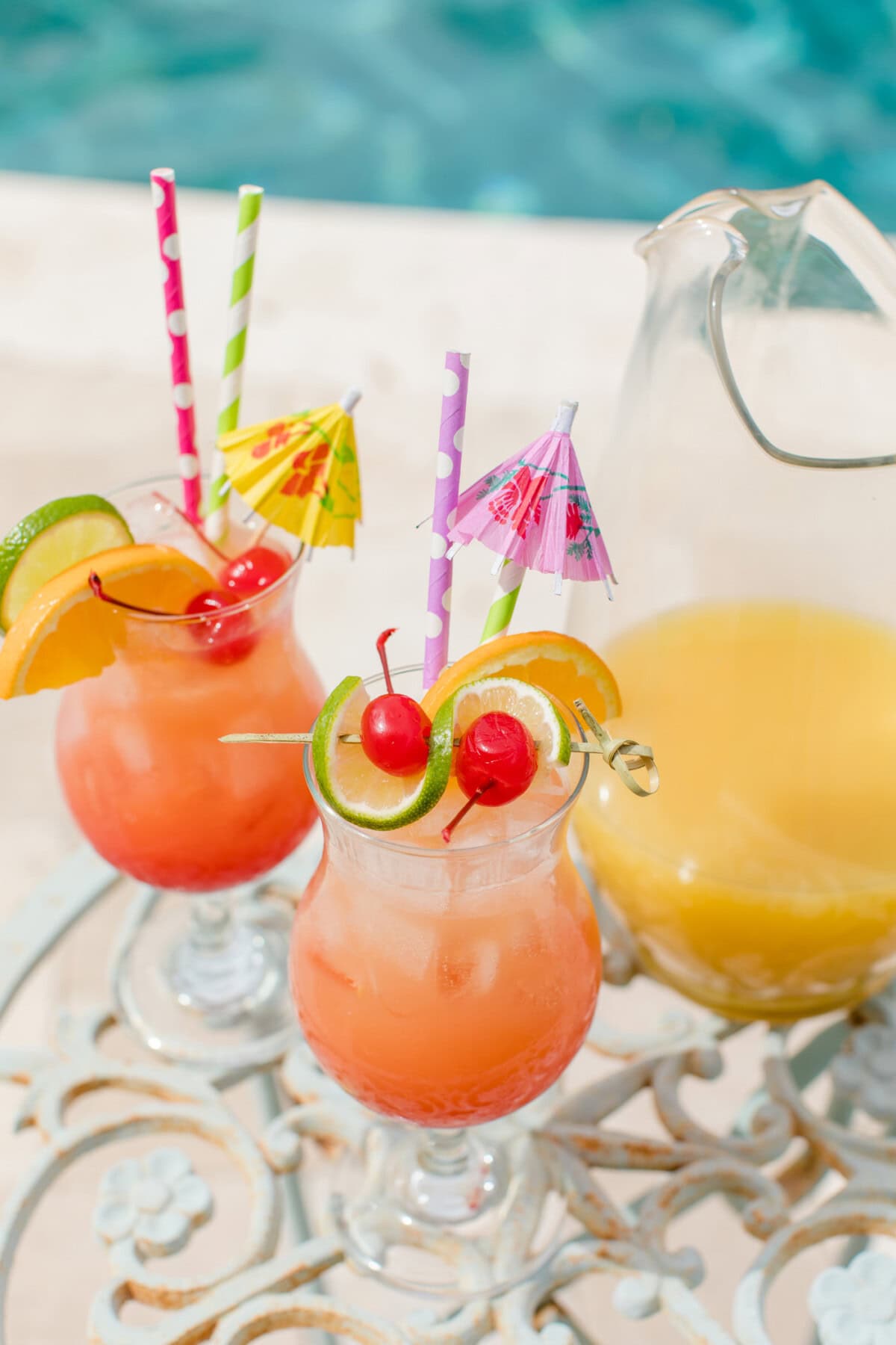 2 glasses of rum punch by the pool