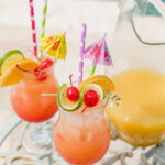 2 glasses of rum punch by the pool