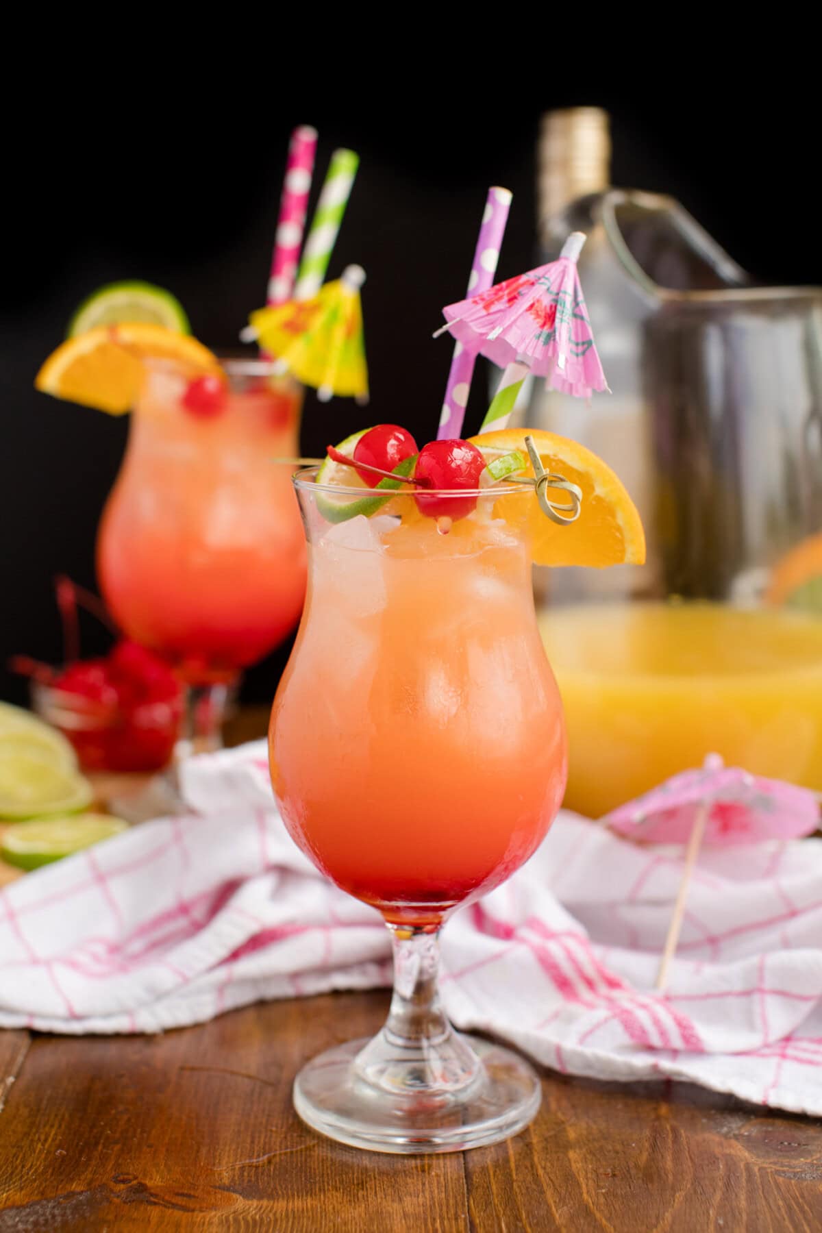 two glasses of rum punch with a black background