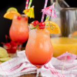 two glasses of rum punch with a black background