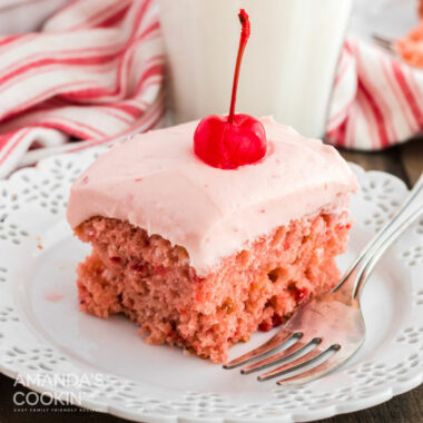 slice of cherry cake on plate with a fork