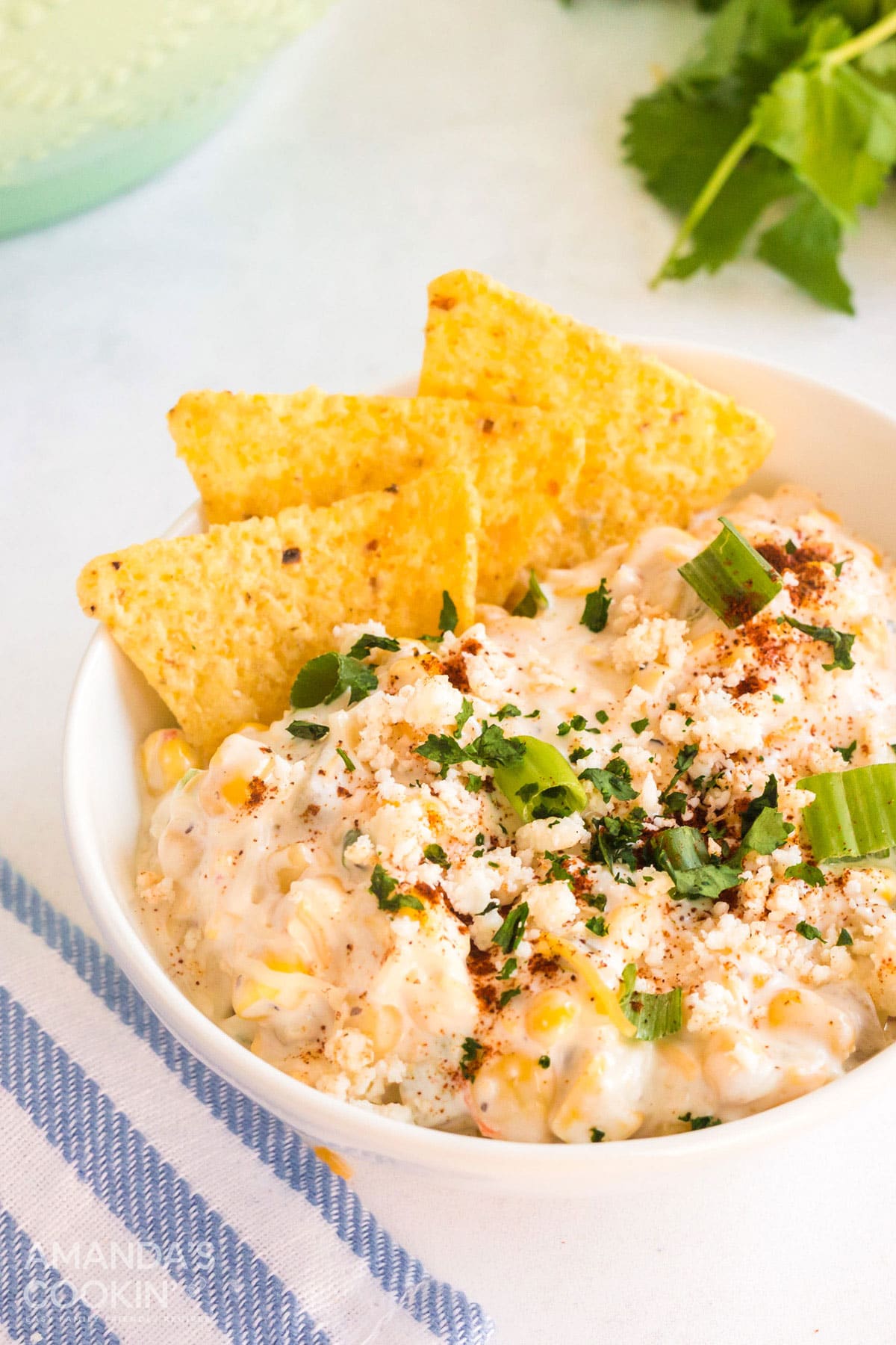 bowl of corn dip with tortilla chips placed in it