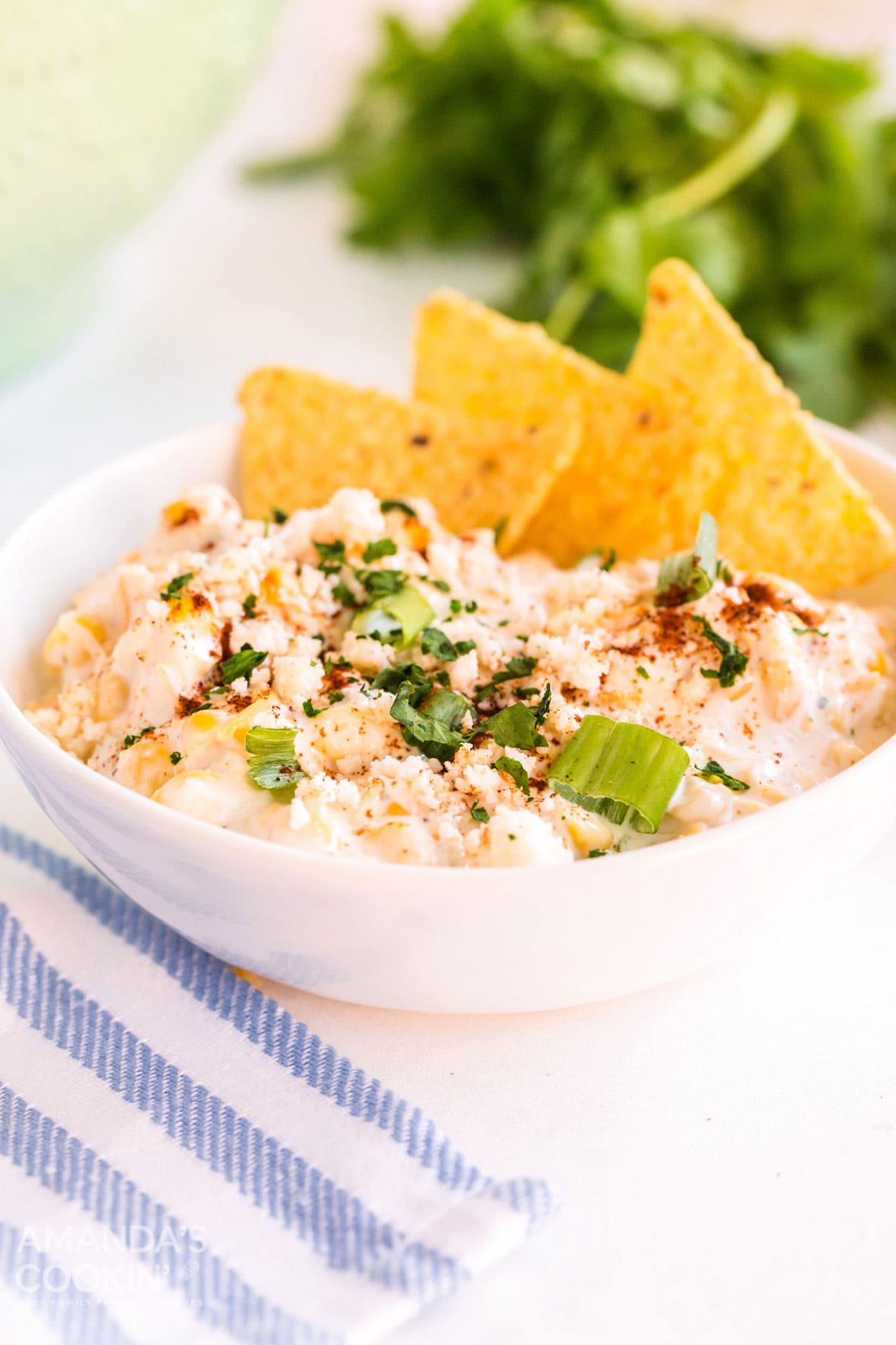 white bowl of corn dip with tortilla chips