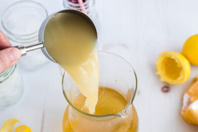 Pouring lemon juice into a pitcher