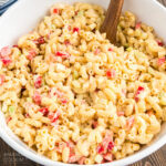 bowl of macaroni salad with a wooden spoon