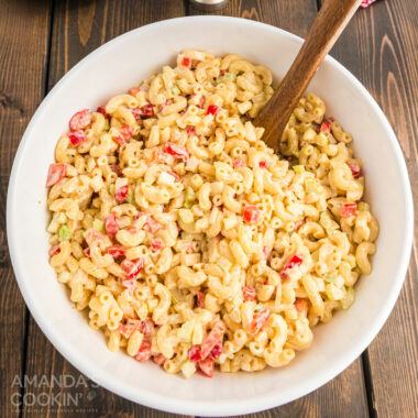 wooden spoon in a bowl of macaroni salad