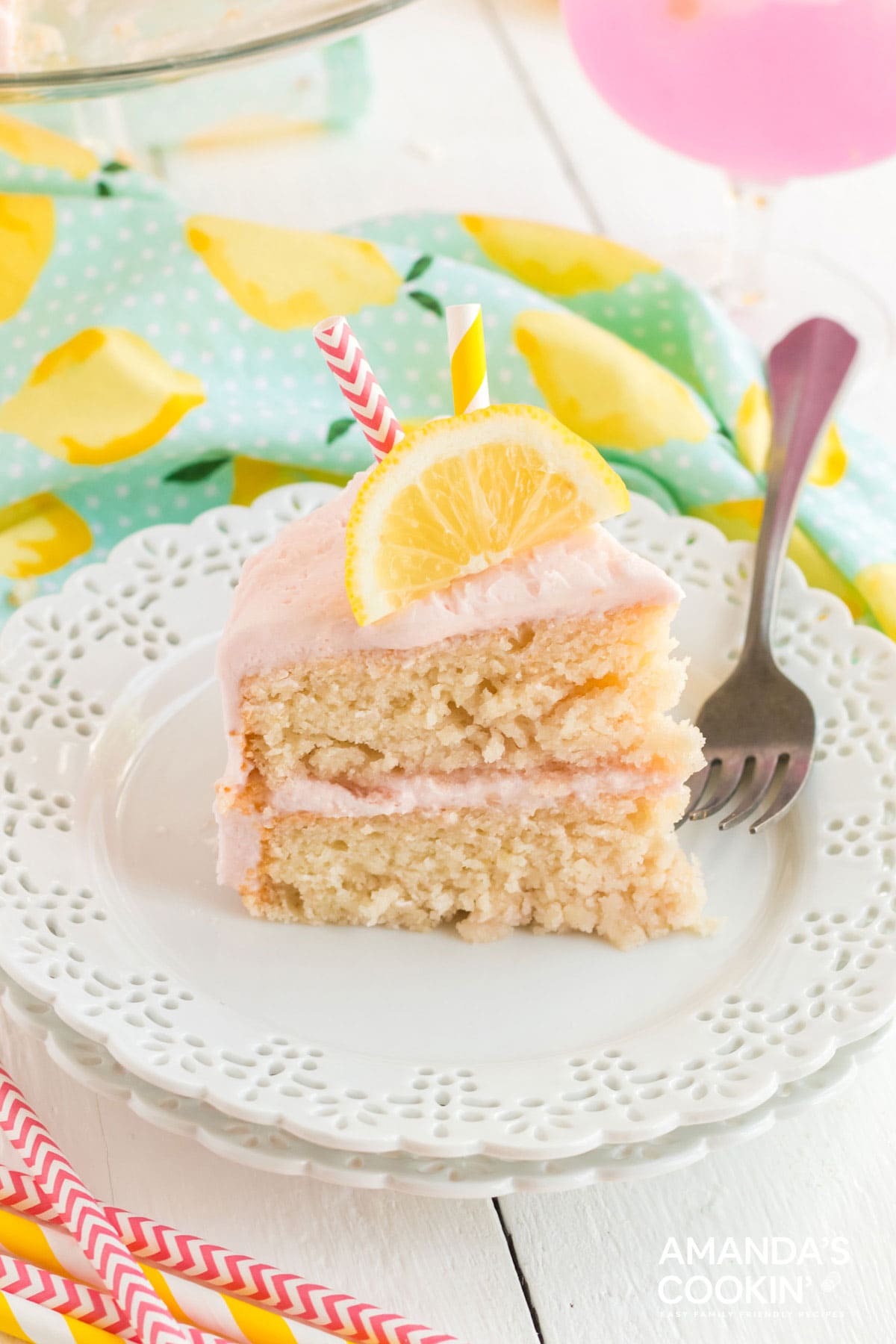 Slice of pink lemonade cake on a plate