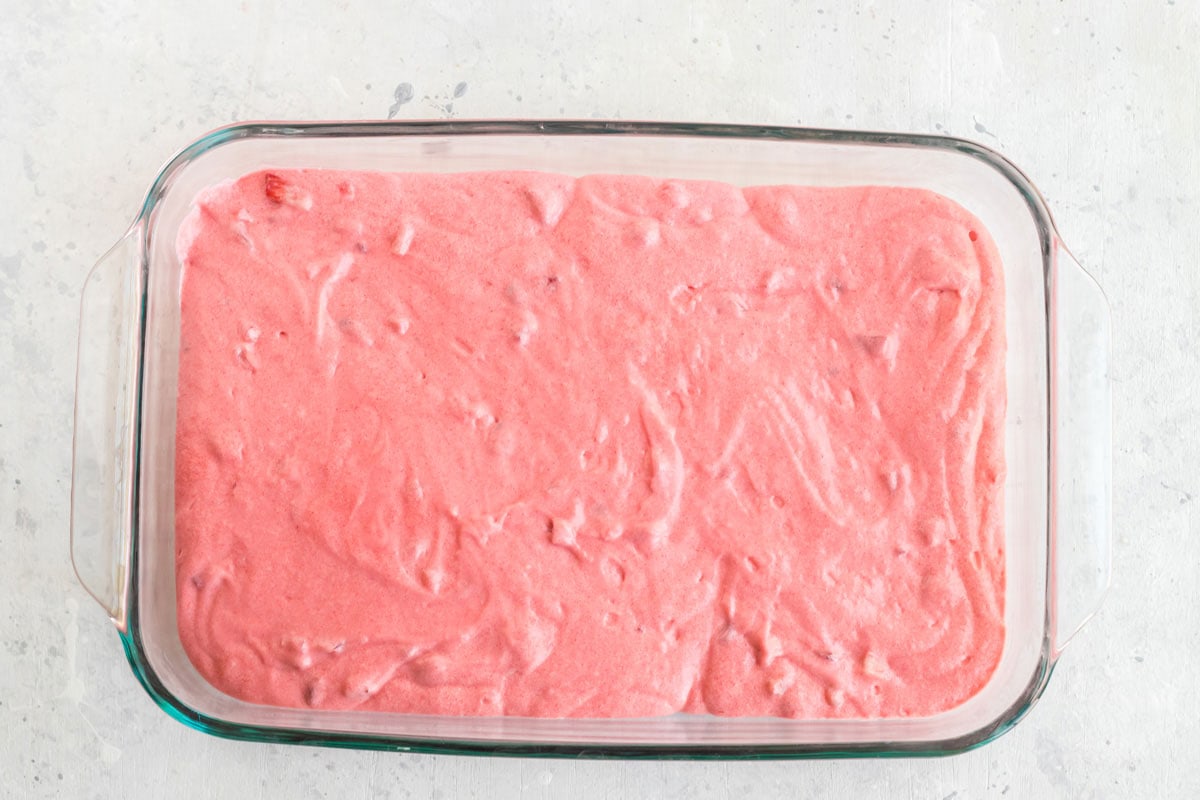 pink cake batter in a 13x9 pan