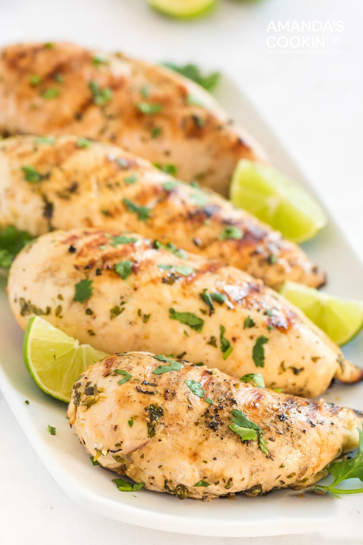 cilantro lime grilled chicken breasts on a white plate