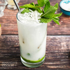 coconut mojito garnished with fresh mint and coconut flakes