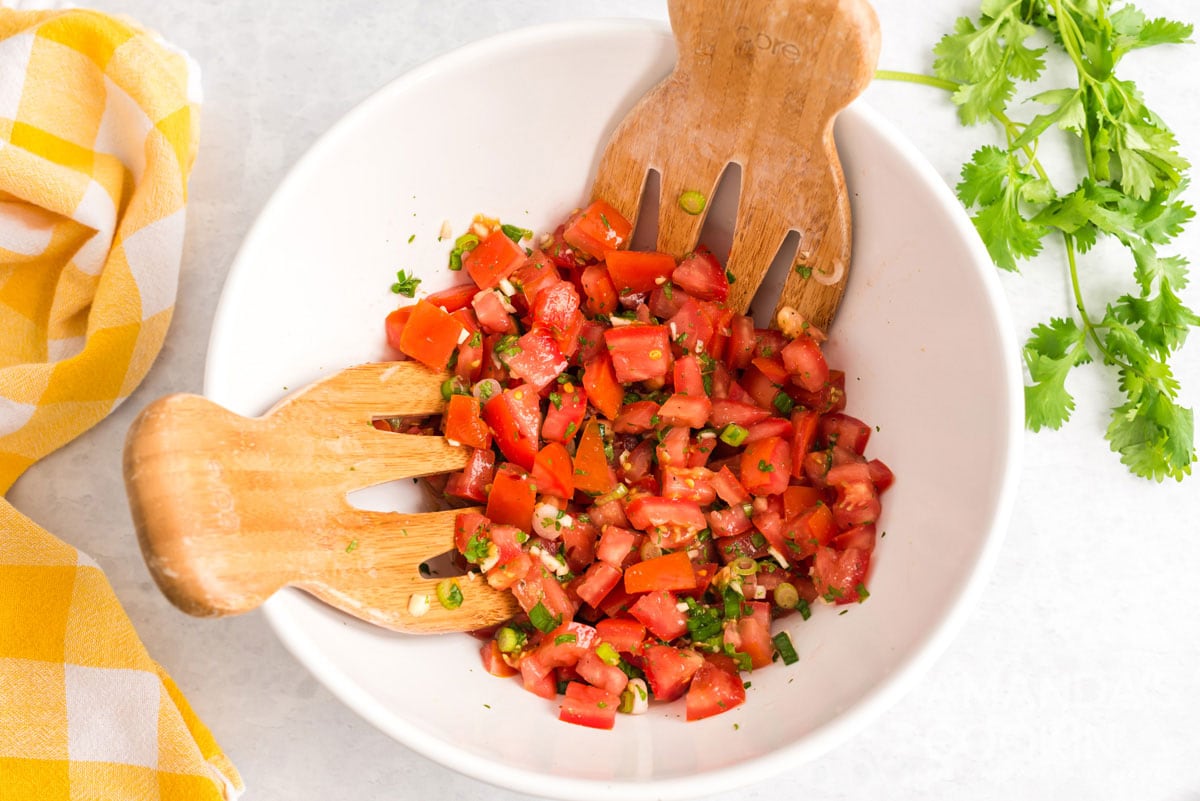 salsa fresca with salad tossing spoons