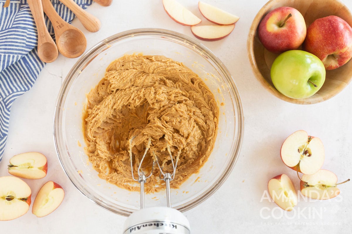 peanut butter apple dip being blended by a hand mixer