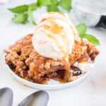 dish of crockpot apple cobbler with vanilla ice cream