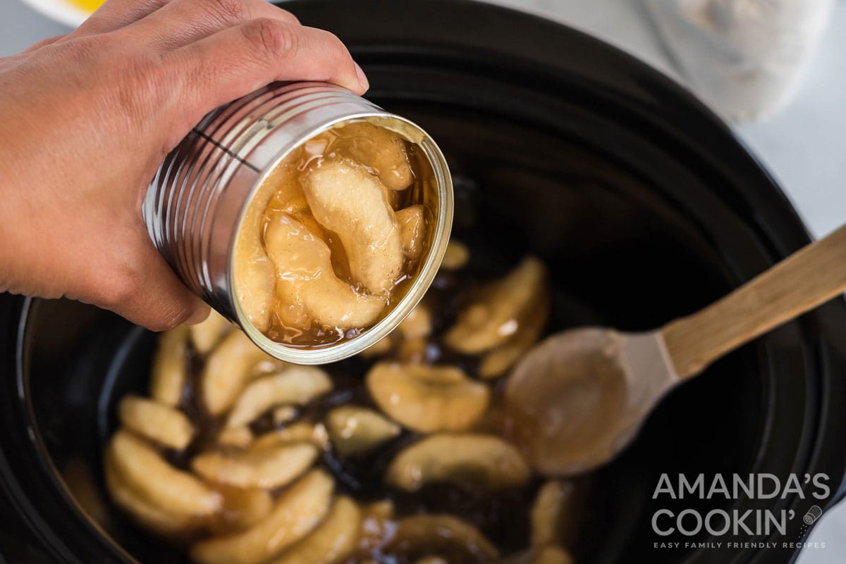 emptying apple pie cans into crockpot