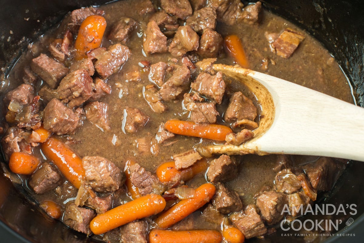 stirring beef in slow cooker