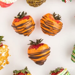 3 orange and brown chocolate covered strawberries