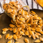 jar of pumpkin seeds knocked over and spilling out