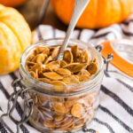 small jar of pumpkin seeds with a spoon