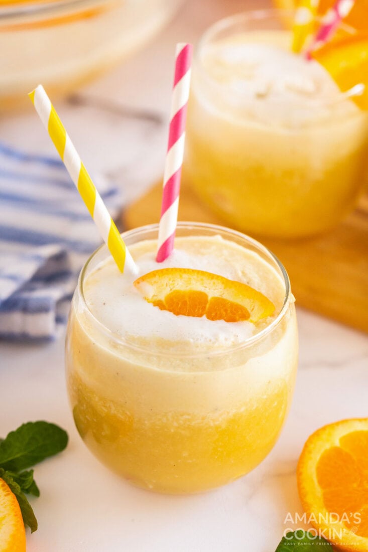 glass of orange punch with straws