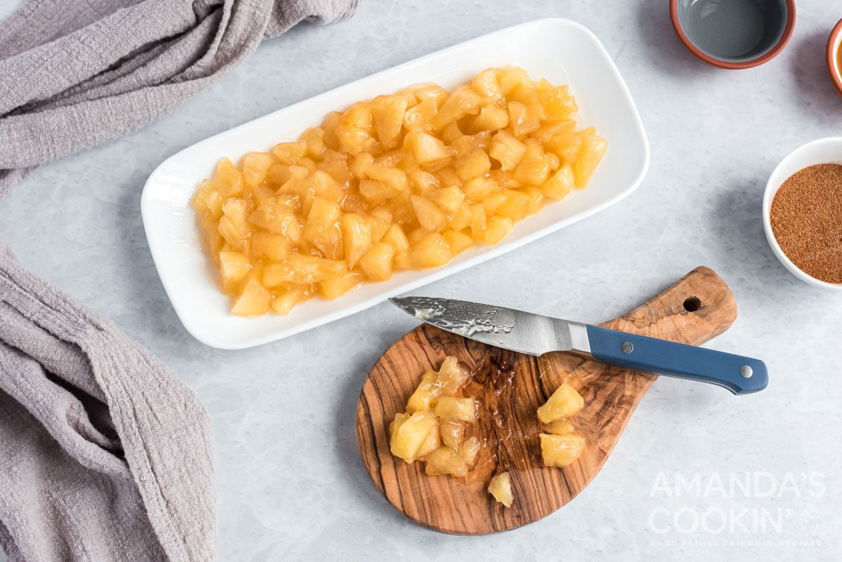 apple pie filing and a cutting board and knife