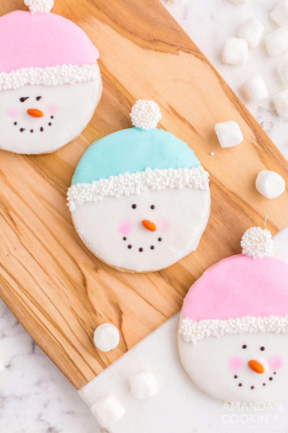 snowman cookies on cutting board