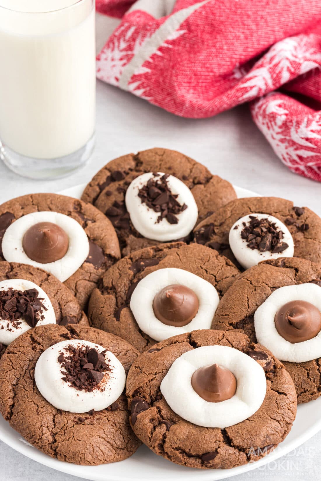 hot cocoa cookies on a plate with glass of milk