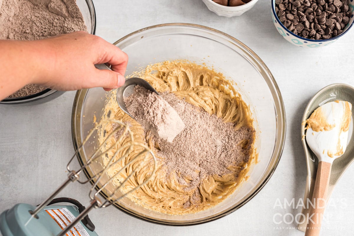 adding flour mixture to cookie dough