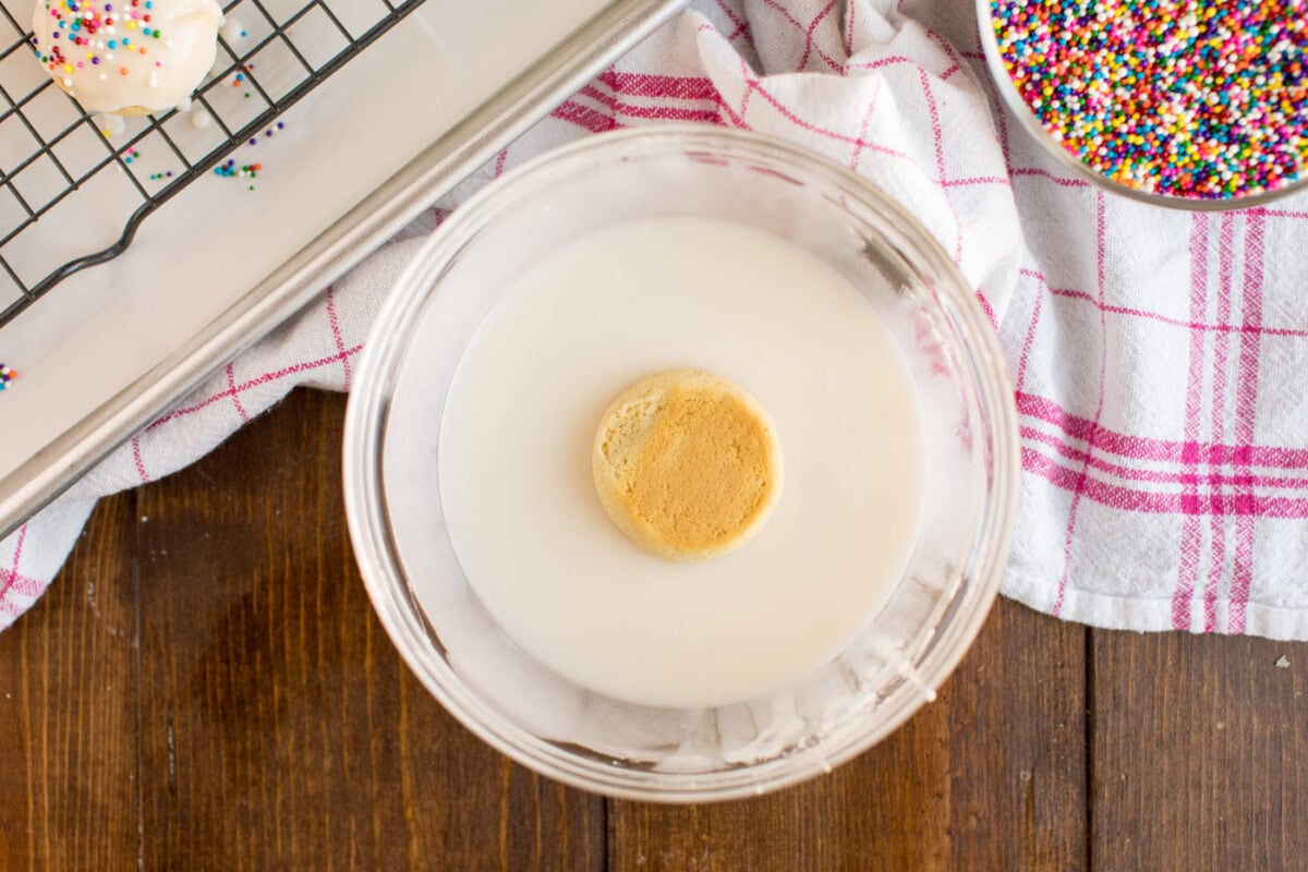 dipping cookie in glaze