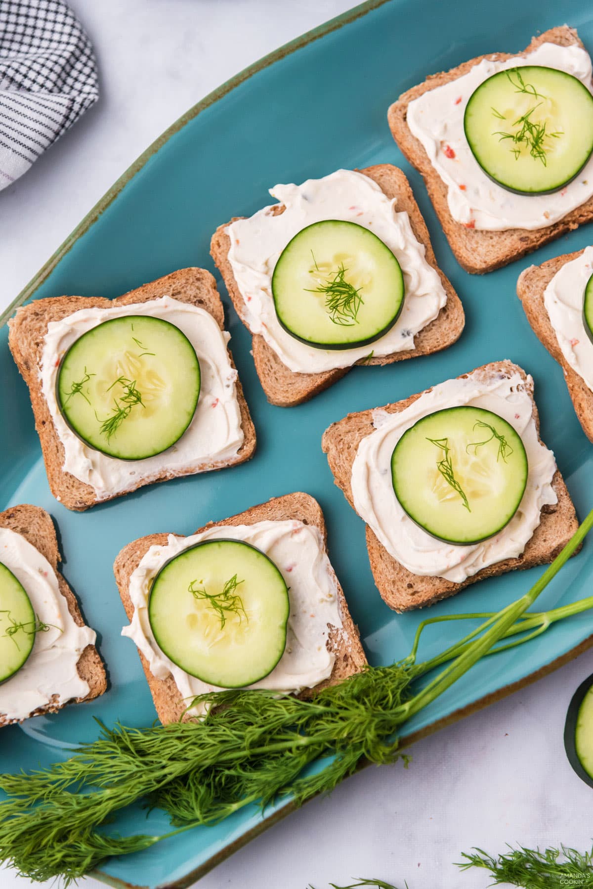 CUCUMBER SANDWICHES ON A BLUE PLATTER