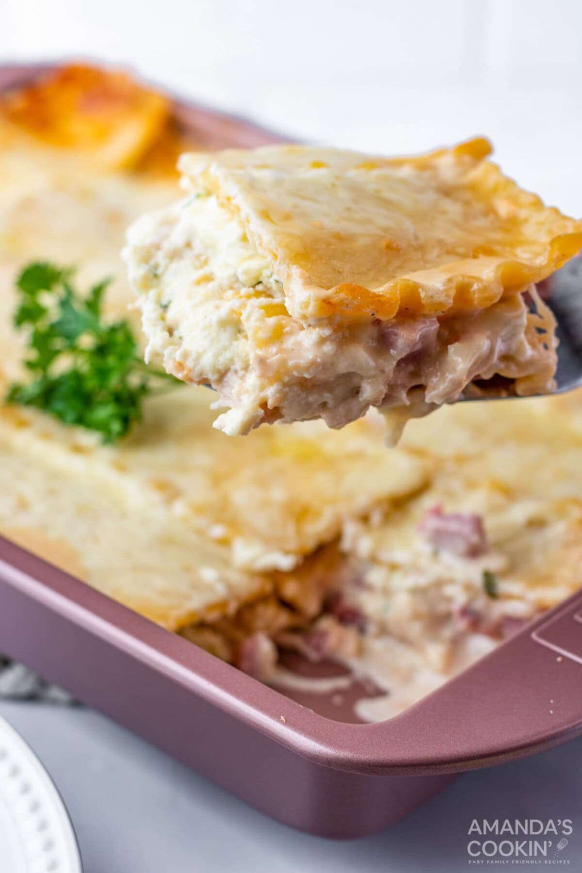 liftin a slice of chicken cordon bleu lasagna