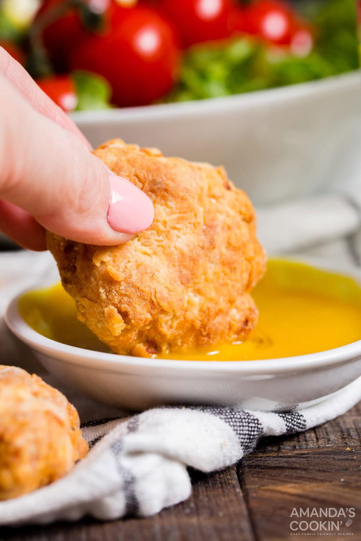 dipping chicken nugget into mustard