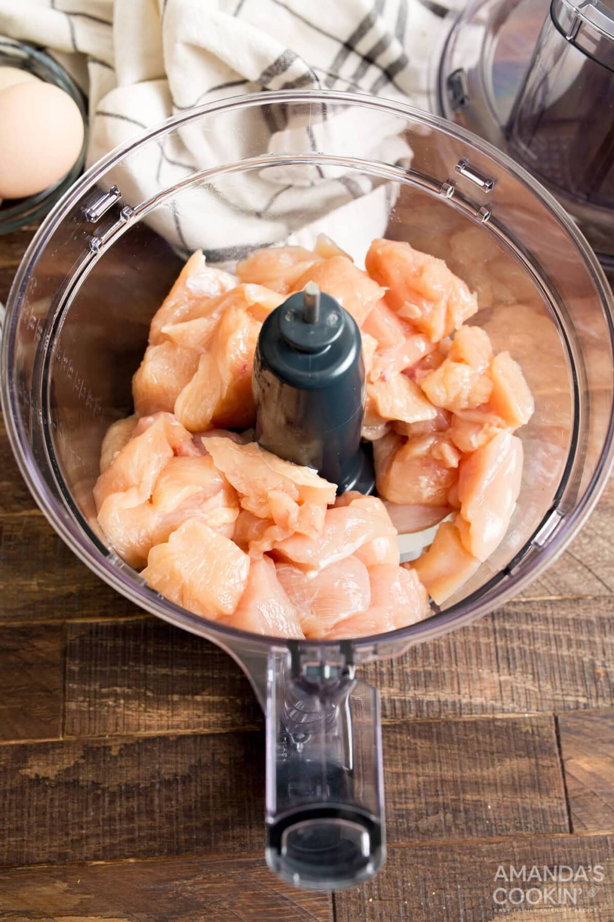cubed chicken in a food processor bowl