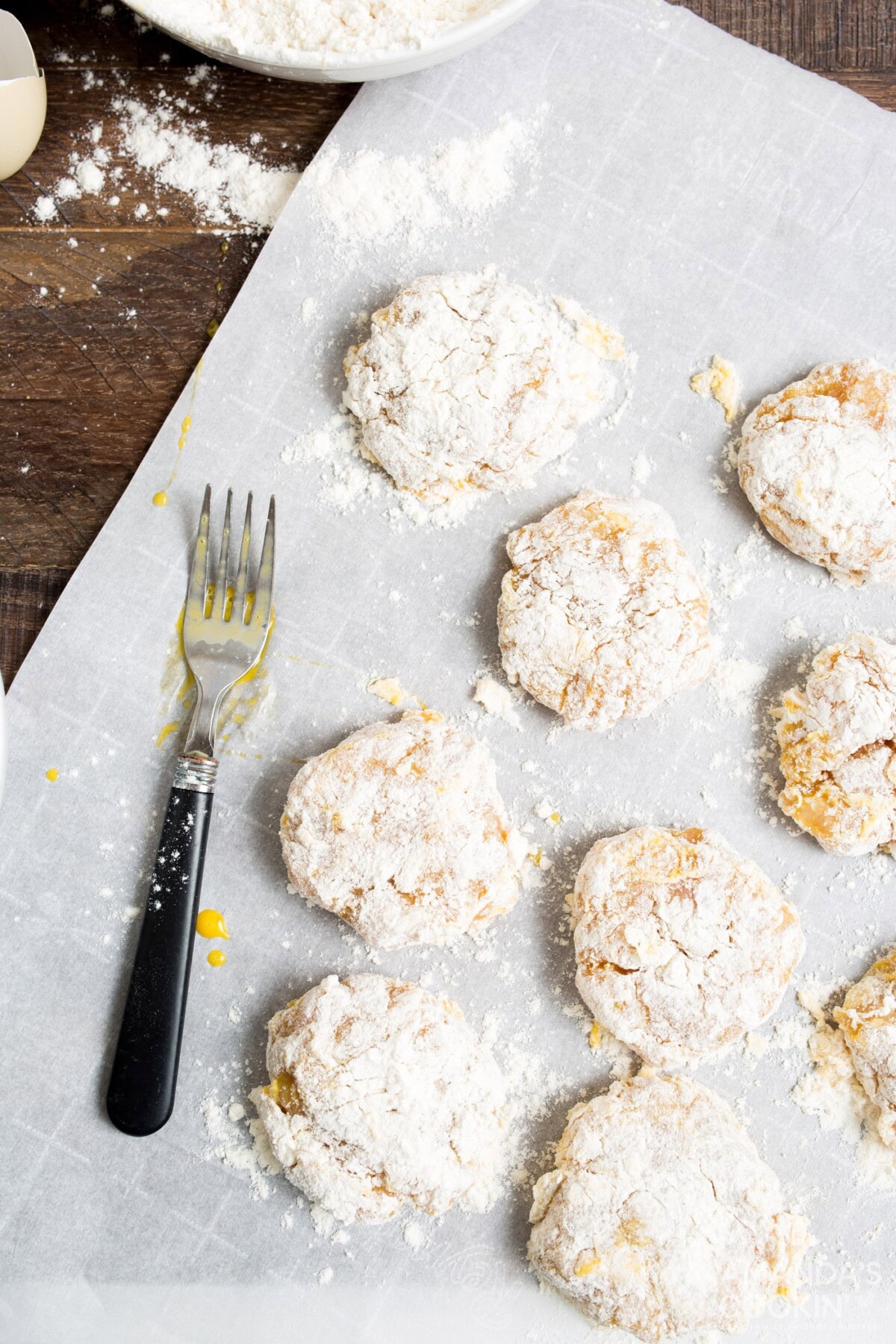 four coated chicken nuggets on parchment