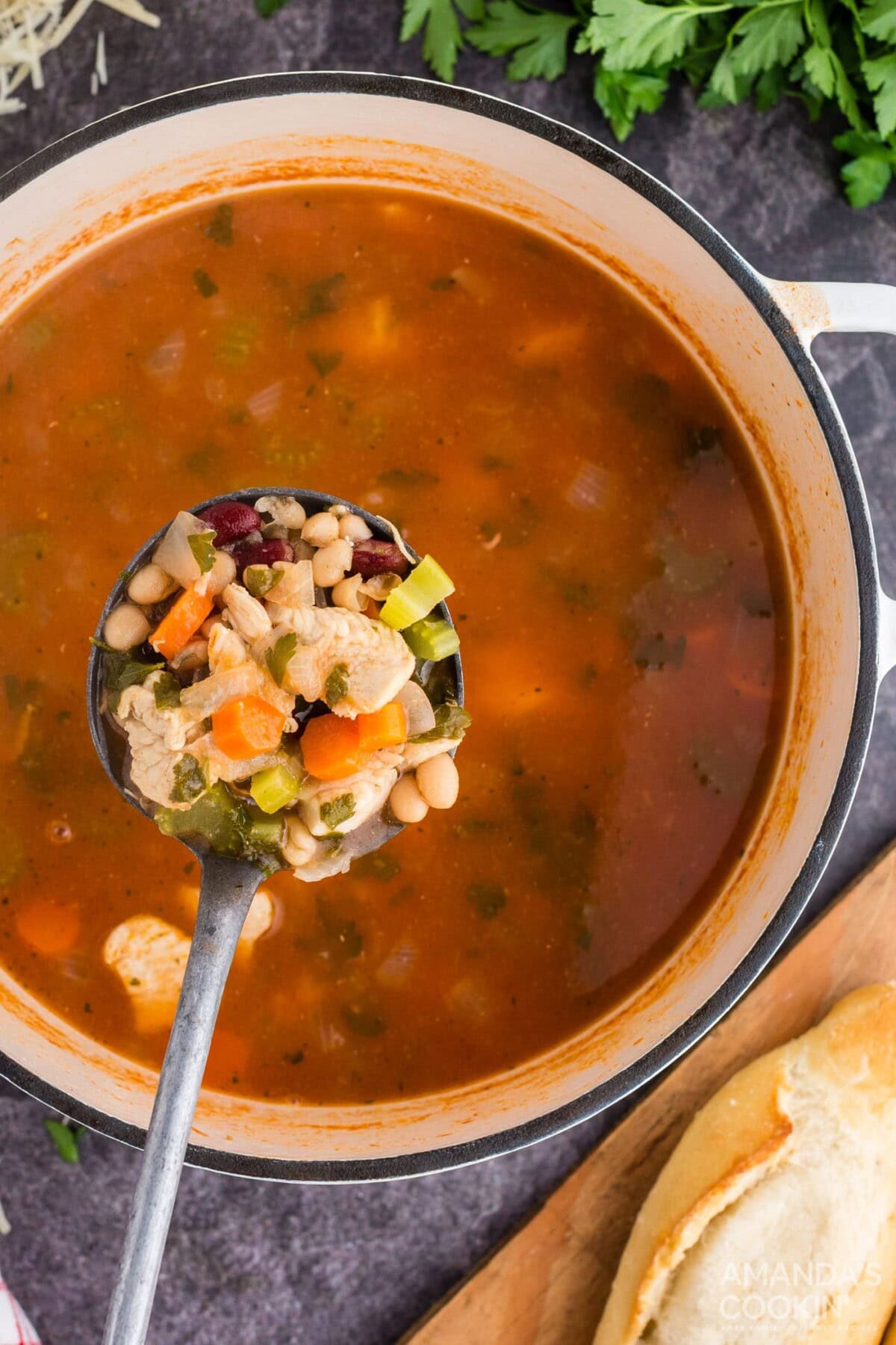 ladle full of chicken bean soup