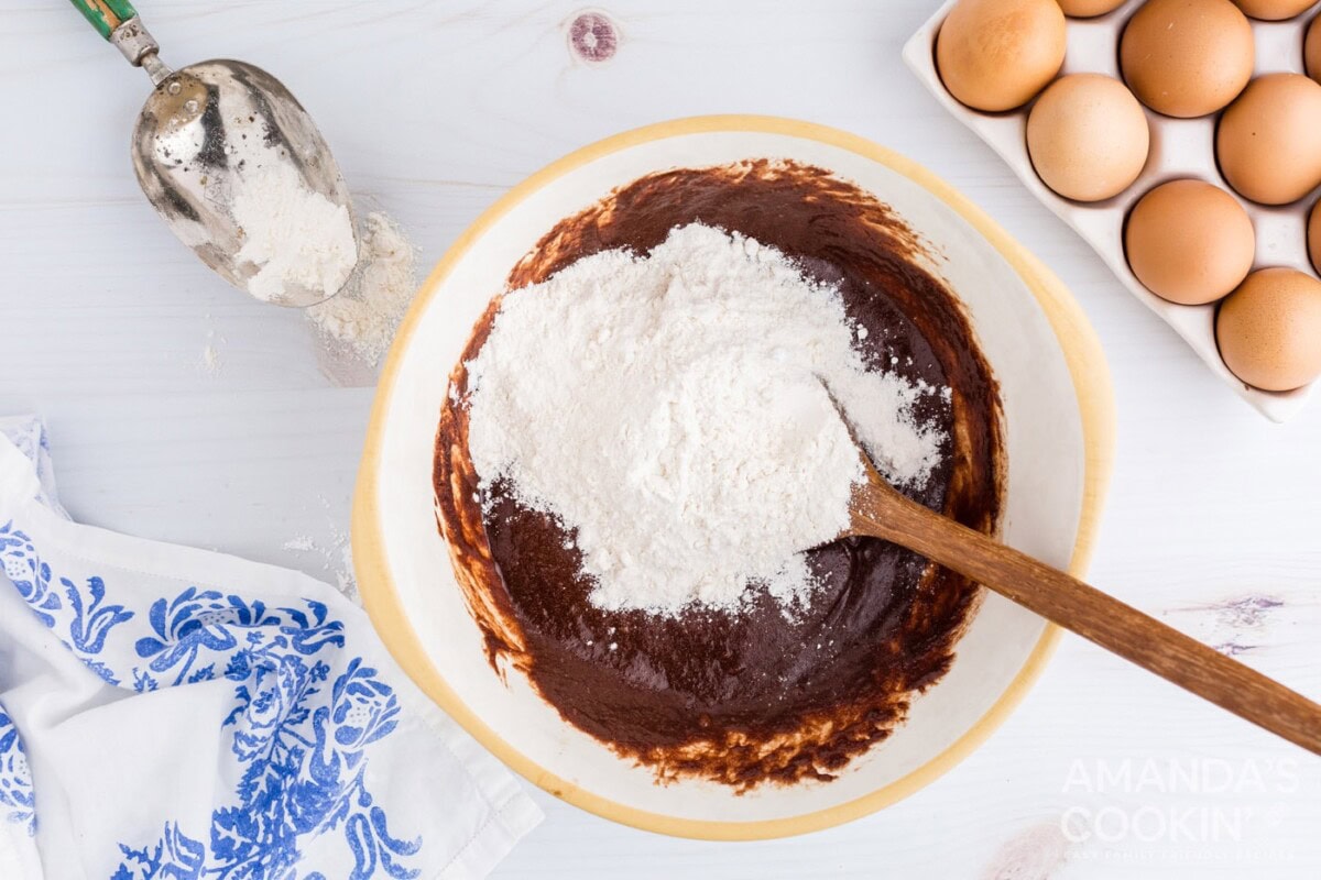 adding flour into mixture in bowl