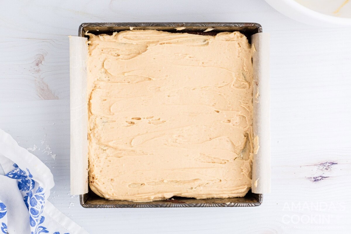 peanut butter frosting spread over brownies