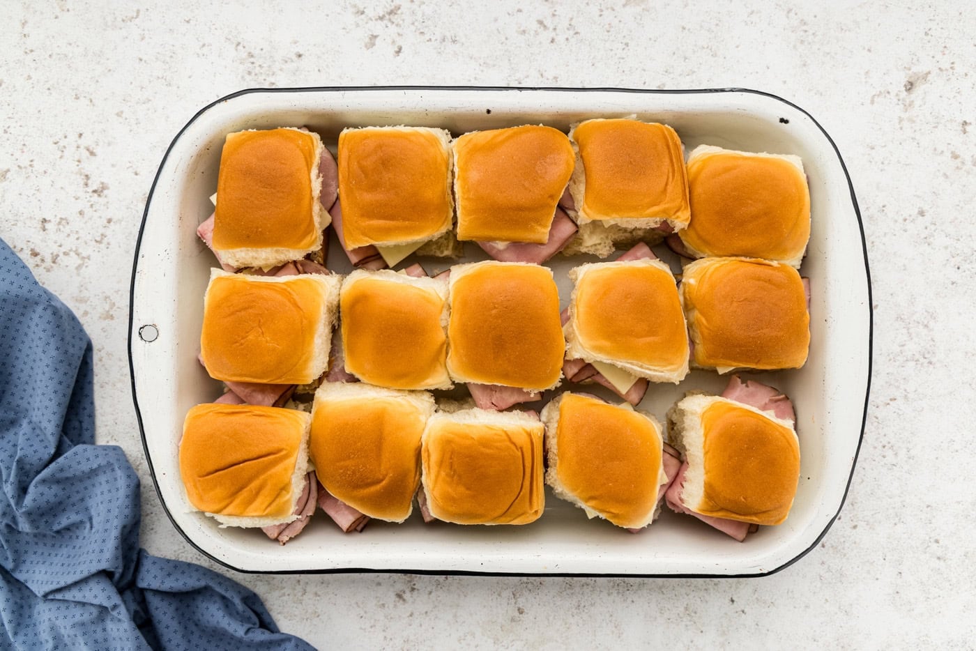 ham and cheese sliders in a casserole dish