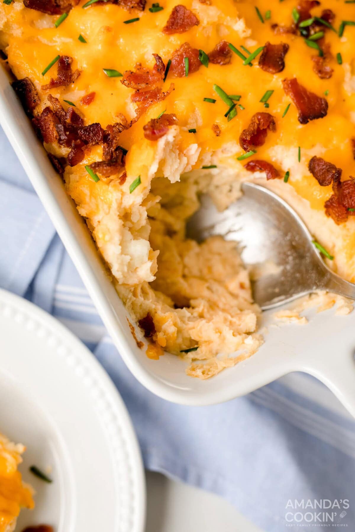 spooning out potato casserole