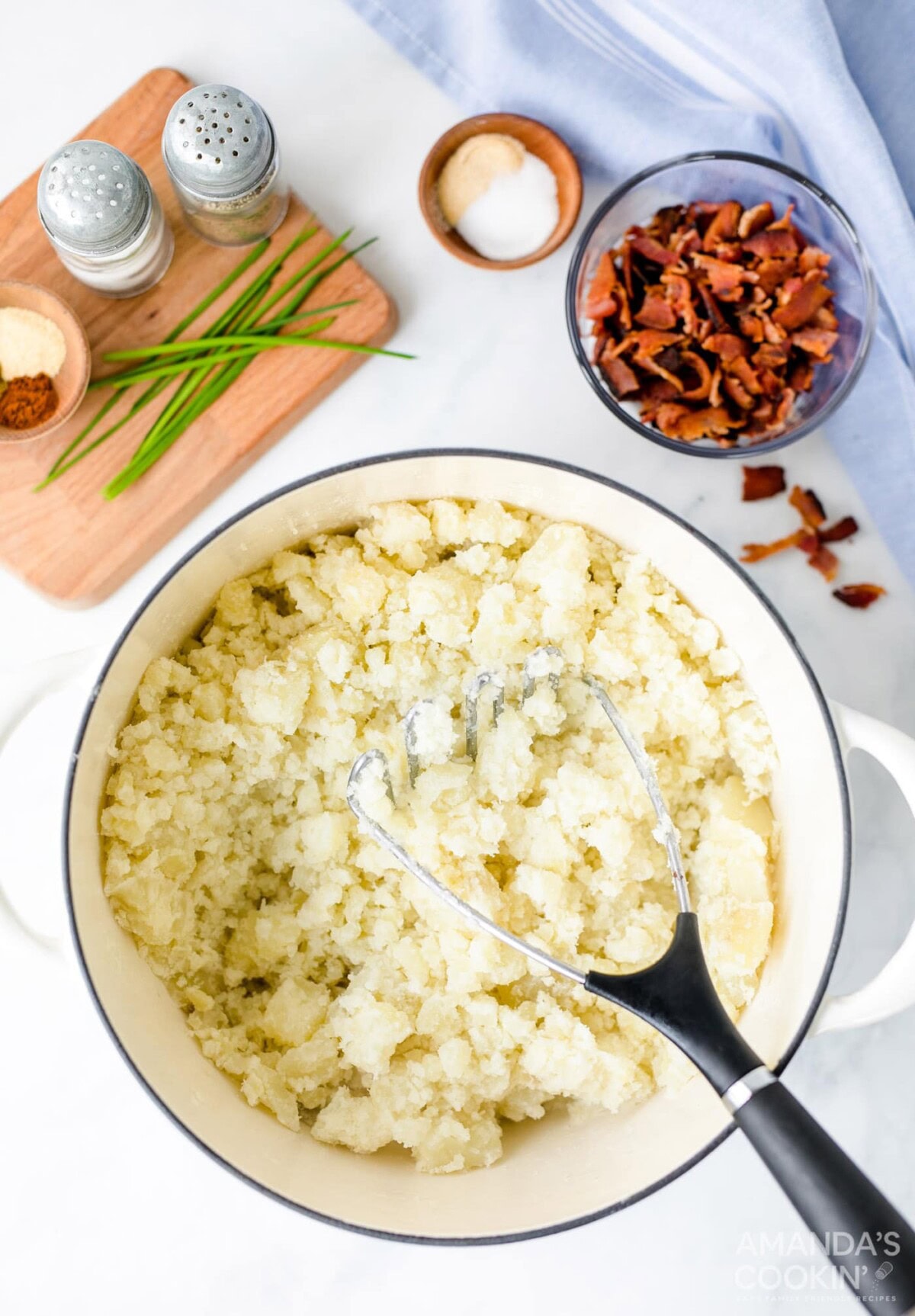 mashing potatoes in a pot