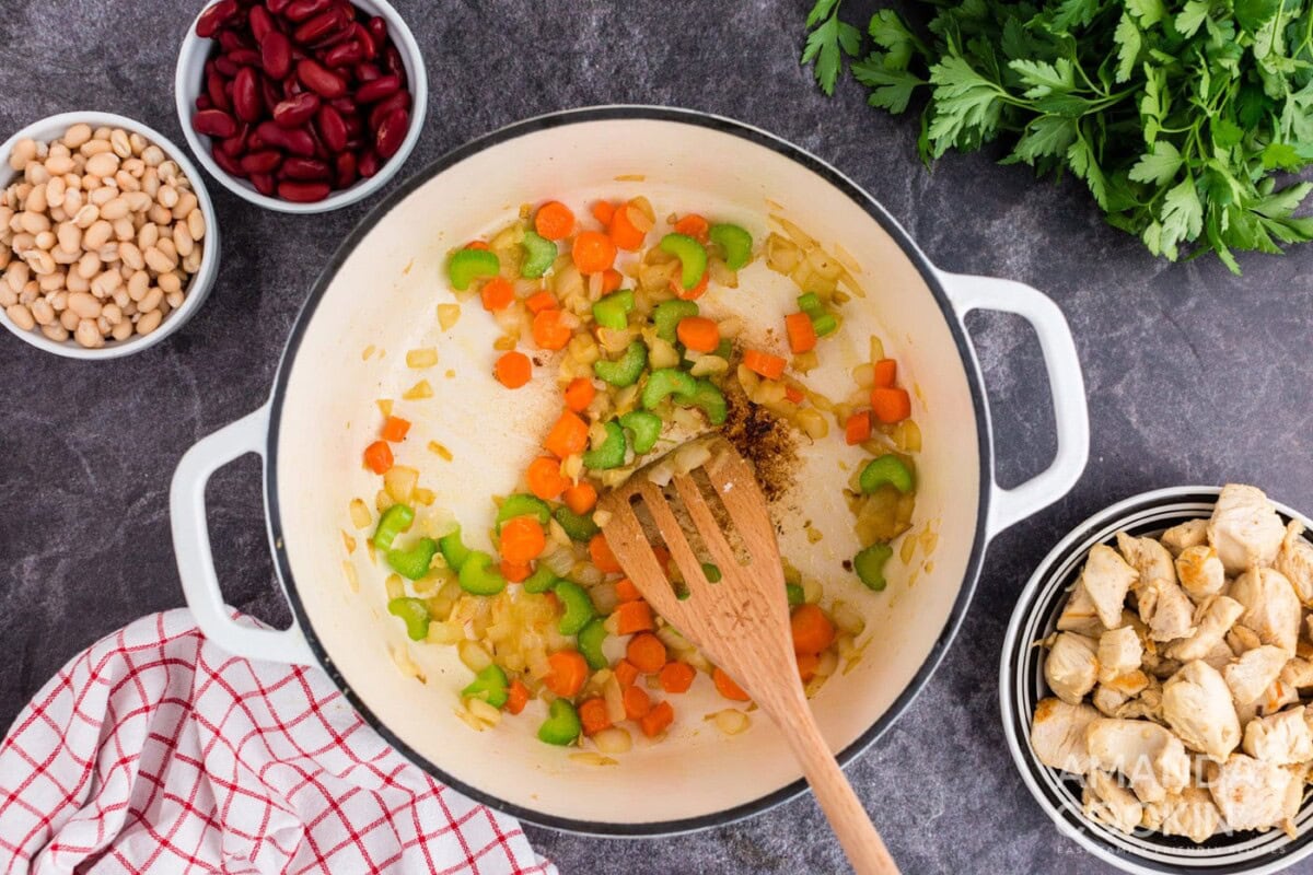 celery, onion, carrots, and pureed tomatoes in dutch oven