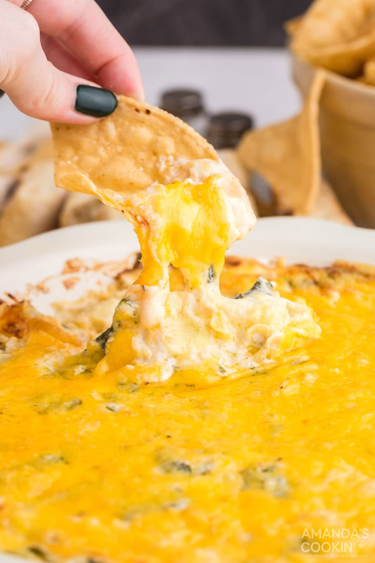 dipping chip in spinach dip