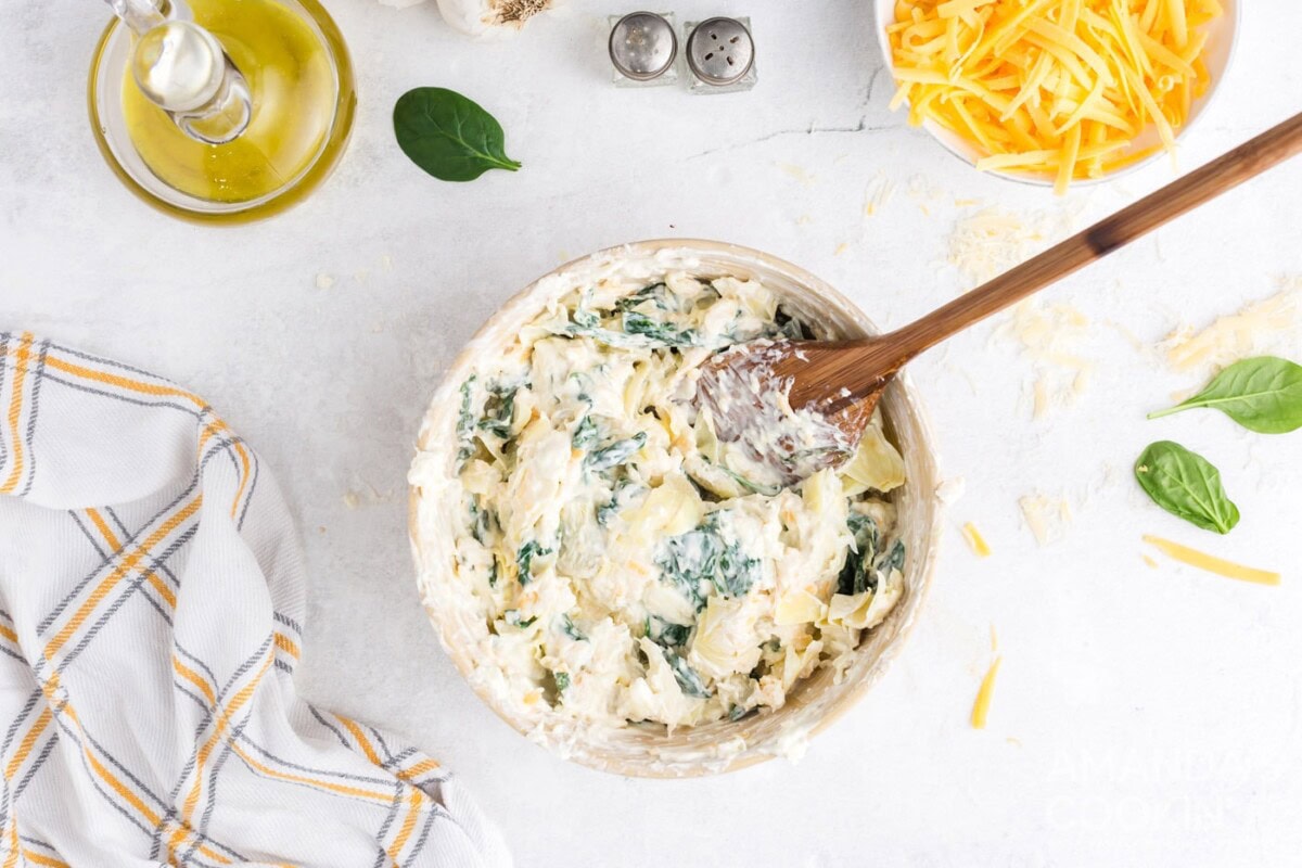 adding in the spinach mixture to bowl