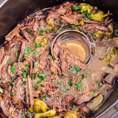 ladle in a crockpot of mississippi pot roast