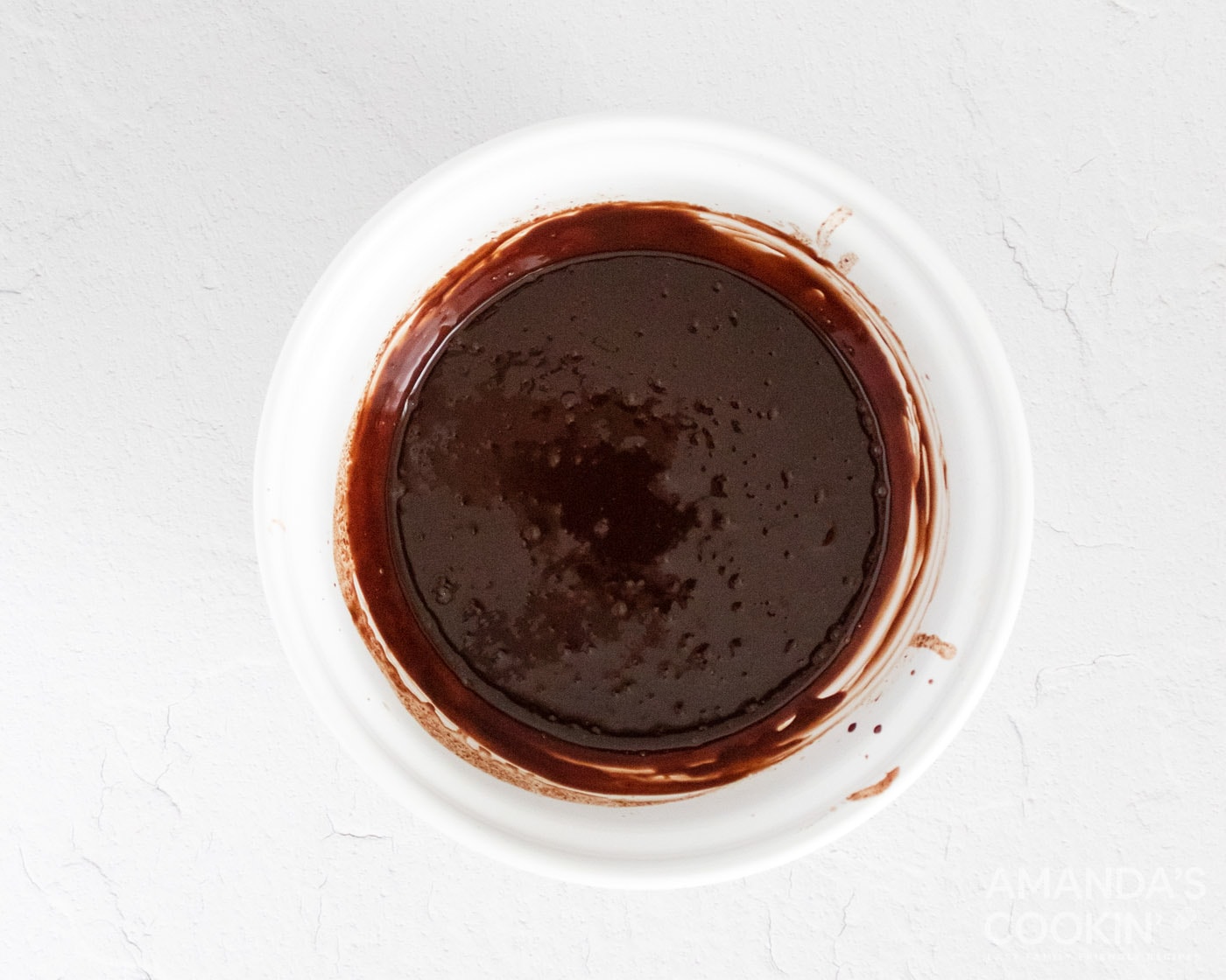 melted coconut oil and chocolate mixed in a bowl